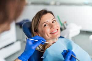 A woman smiling during a dental cleaning